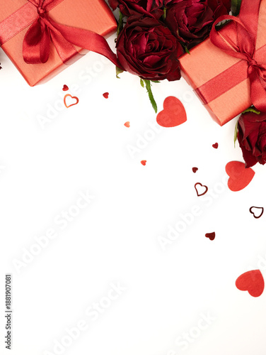 Beautiful and festive background for valentines day or anniversary celebration in pink with pink present and red ribbons roses and copy space 