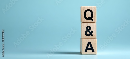 The Q&A wooden blocks representing questions and answers concept on blue background