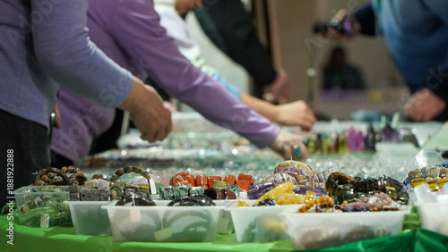 The woman chooses jewelry at a night fair
