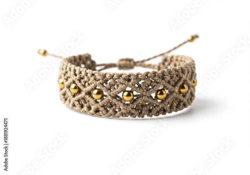 Intricately woven macrame bracelet in beige with metallic gold beads, adjustable with drawstring, representing handmade fashion.
