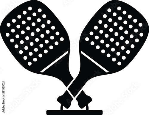 Two black and white paddle rackets with dots crossed over each other sport