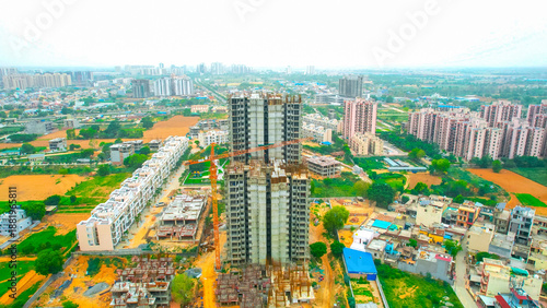 under construction building with crane and metal rebar sticking out showing rapid development on the outskirts of delhi, mumbai, hyderabad, cochin, bangalore