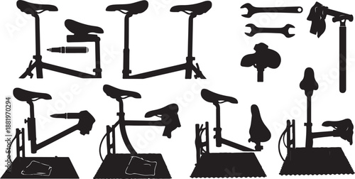 Silhouettes of bicycle repair stands and tools on white