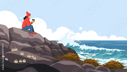 Woman in red sitting on rocks by the ocean with a hot drink