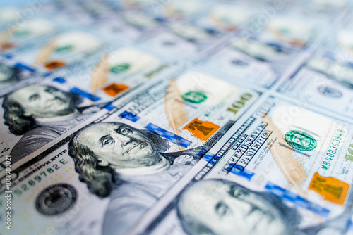 American bills of 100 US dollars are laid out on the surface and occupy the entire area of ​​the image, the background is made of American dollars, greenbacks of large denominations