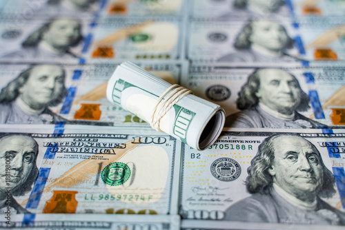 American bills in denominations of 100 US dollars are laid out on the surface and occupy the entire area of ​​the image, the background is made of American dollars, greenbacks of large denominations, 
