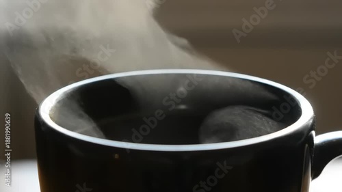 Steaming Hot Coffee in Black Mug.