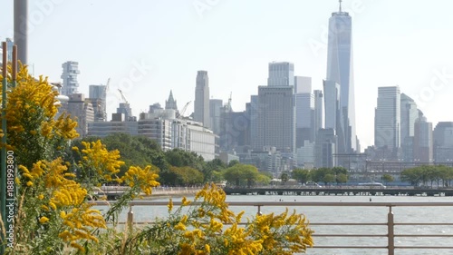 Wallpaper Mural New York City Manhattan downtown financial district skyline, United States. Urban waterfront cityscape with skyscraper buildings, World Trade Center tower from Hudson River Park, riverfront promenade. Torontodigital.ca