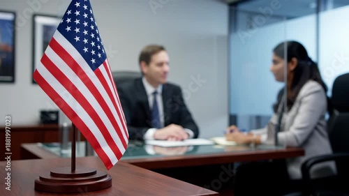 US Flag In Focus At Consulate With Visa Interview In Background.