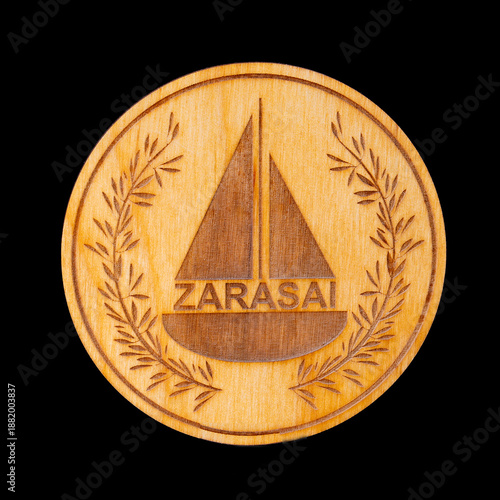 The symbol of the city of Zarasai is burned onto a round wooden plaque