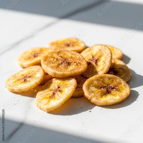 Crispy Banana Chips with Cinnamon and Salt Sprinkled on White Marble Surface