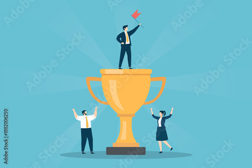 Businessman holding a red flag on top of a giant gold trophy with a male and female coworker cheering below, symbolizing team achievement and victory.