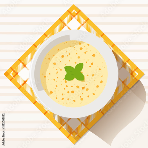 Bol de soupe crémeuse sur serviette à carreaux