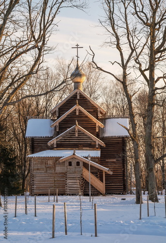 Ancient log church in the winter forest