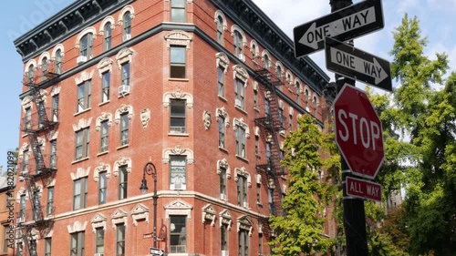 Wallpaper Mural New York City Greenwich and Perry street corner, sign in Manhattan West Village, United States. Urban road sign, traffic sign in NYC. Red brick classic building architecture. Lantern, One way and Stop Torontodigital.ca