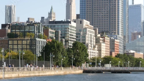 Wallpaper Mural New York City Manhattan downtown financial district skyline, United States. Urban waterfront cityscape, World Trade Center skyscraper building, Hudson River Park, people walk on riverfront promenade. Torontodigital.ca