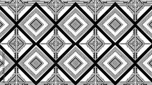 Geometric pattern featuring diamond shapes in black and white, creating a repeating design with intricate details