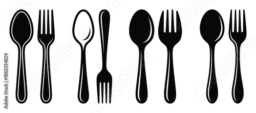 Minimalist black and white silverware set. Flat lay of spoons and forks in horizontal arrangement.
