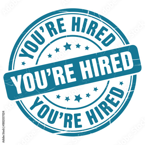 a blue circular stamp with the words you re hired prominently displayed