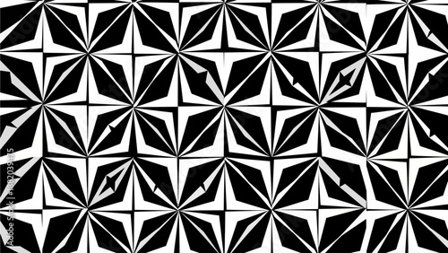 Geometric pattern of black and white floral shapes in a repeating design viewed from directly above