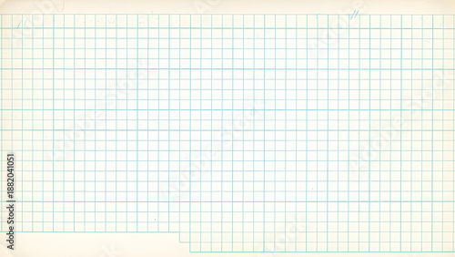 Close-up view of a blank graph paper page with thin teal grid lines and a subtle aged, off-white paper texture, perfect for notes.