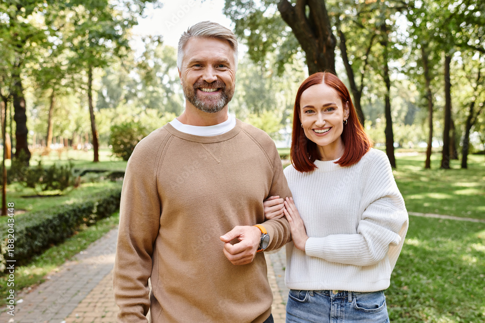 Fototapeta premium Couple enjoying a blissful stroll through a green park in springtime warmth