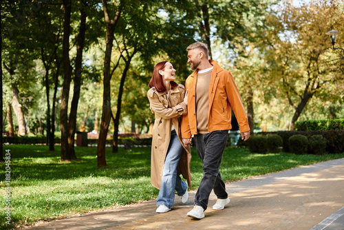 Fotografie Spring stroll through a lush park brings joy to a loving couple