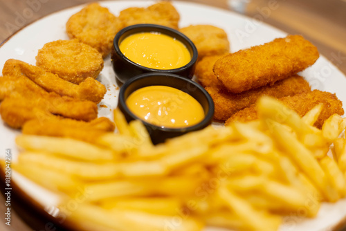 Crispy fried snacks and French fries are served with two cups of cheese creamy dipping sauce.