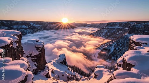 Wallpaper Mural Aerial view of a snow-covered canyon at sunrise with clouds below, showcasing rugged cliffs and a serene landscape. Torontodigital.ca