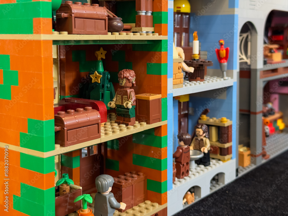 Fototapeta premium A detailed cross-section of a custom LEGO building featuring various furnished rooms, including a festive scene with a werewolf figure and a Christmas tree: 06/10/2024-Ljubljana, Slovenia