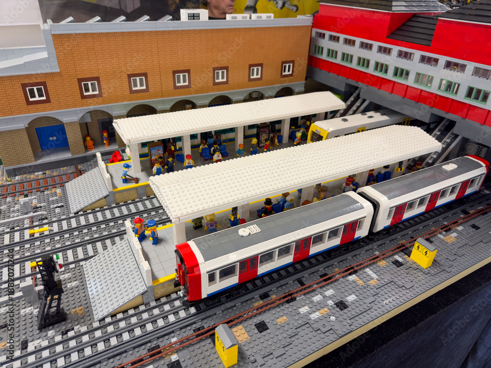 Fototapeta premium Miniature railway station diorama with passenger trains, platforms, and commuters built from lego plastic bricks.:06.10.2024-Ljubljana, Slovenia