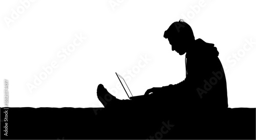 Silhouette of a person sitting and working on a laptop, depicting concentration and digital engagement in a stark, high-contrast setting.