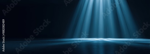Dark background with dramatic blue light beams illuminating a reflective surface