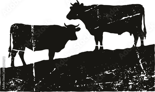 Silhouette of two cows standing on a hill in black and white design