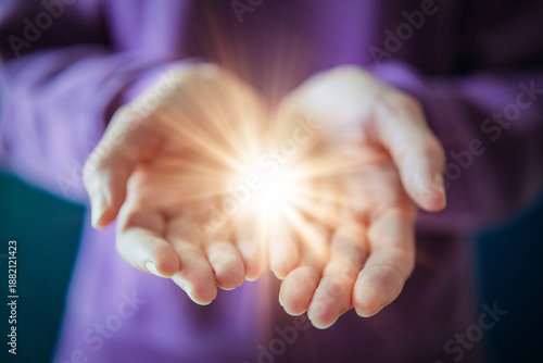 Woman Holding Glowing Light in Open Hands as Give to Gain Symbol of Empowerment and Sharing