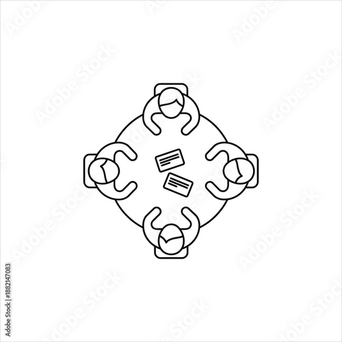 a round table with four people seated around it and documents in the center