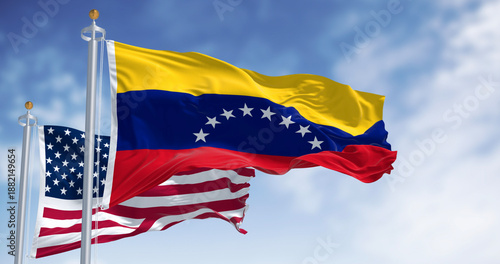 Venezuela and US national flags waving in the wind on a clear day