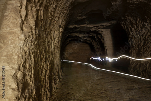 Abstract light movement in dark rock tunnel called chalk mine in Mexico
