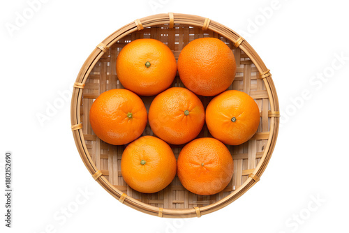 Fresh and vibrant ripe oranges artfully arranged in a traditional bamboo basket, photographed from above on a clean white background, emphasizing natural citrus zest