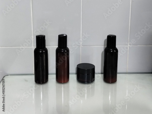 Four bottles of beauty products side by side