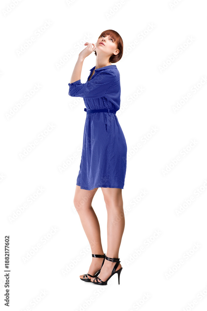 Fototapeta premium Woman in blue dress posing in studio, isolated on white background