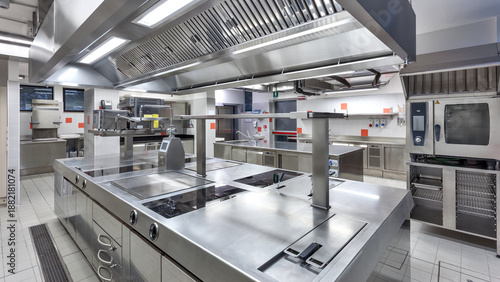 Photos Industrial-grade kitchen with stainless steel surfaces, central island, and advanced appliances for high-volume food preparation
