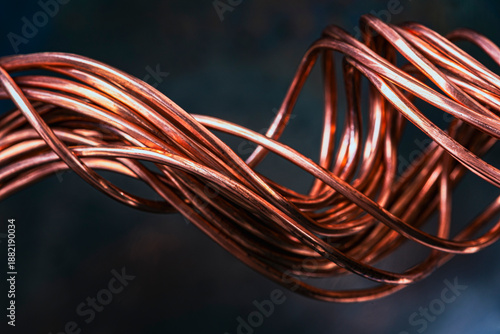 Close-up low angle view of twisted copper wire as a non-ferrous raw material for the electrical power industry, symbolizing conductivity and the flow of energy and data in an industrial environment.