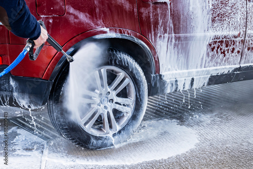 Wallpaper Mural Washing red car in hand car wash. Torontodigital.ca