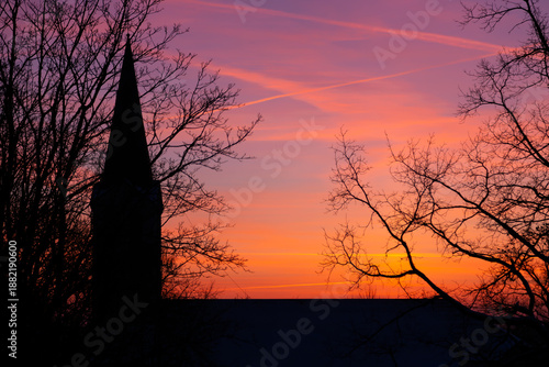 winter sunset behind the silhouette of the church