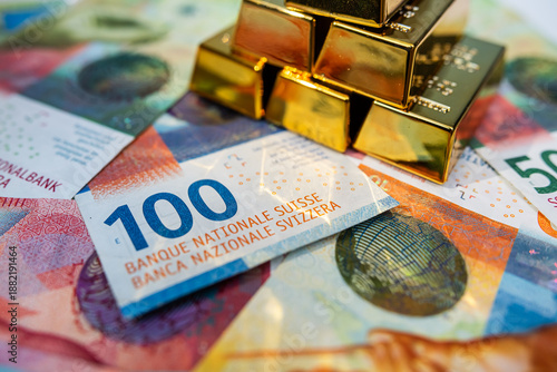 Swiss franc banknotes with gold bars representing wealth, investment security and financial stability