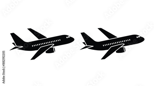 Two commercial airplanes in flight a striking black and white silhouette