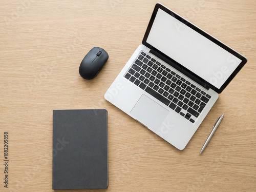 Top view flatlay of a minimalist workspace with a generic wireless mouse, laptop, and office accessories on a light wooden desk. Clean composition symbolizing modern work, organization
