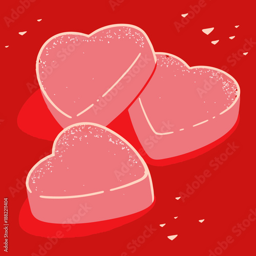 Candy in a heart shape on a red surface