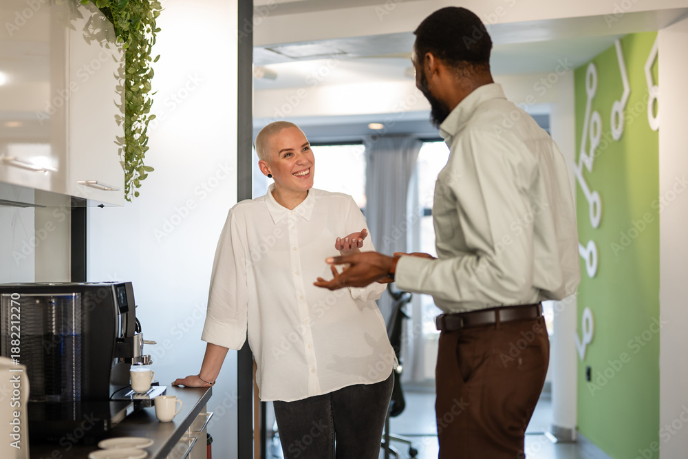 Fototapeta premium Colleagues having coffee break conversation in office kitchen